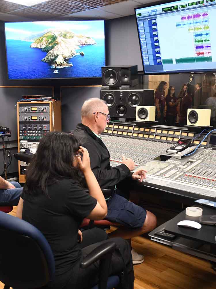 students with audio engineering professor